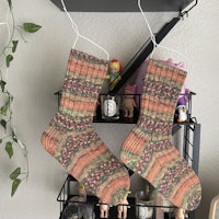 two pairs of socks hanging on a shelf