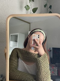a woman taking a selfie in front of a mirror