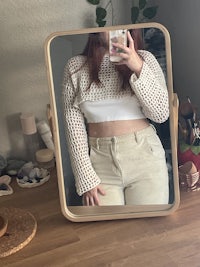 a woman is taking a selfie in front of a mirror